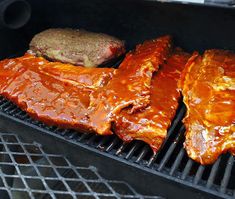 bbq ribs and hamburgers cooking on the grill