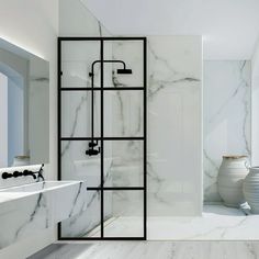 a bathroom with white marble walls and floors