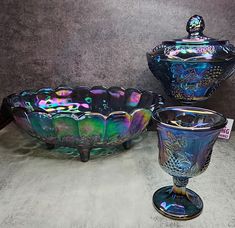 two glass dishes and a bowl on display