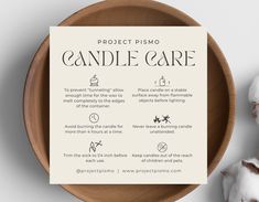 a wooden bowl filled with cotton balls next to a sign that says project pismo candle care