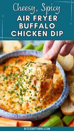 cheesy spicy air fryer buffalo chicken dip in a blue bowl with crackers