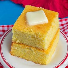 two pieces of cornbread on a plate with a red and white checkered tablecloth