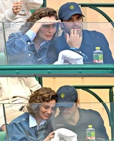 two people sitting in the stands at a baseball game