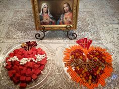 two plates with carrots, celery and candy sticks in the shape of heart