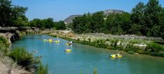 several people are in rafts on the river