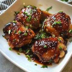 chicken with sesame seeds and sauce on a white plate