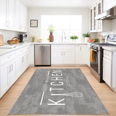 a kitchen area rug with the words kitchen on it in white and gray colors is shown