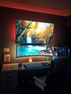 a computer desk with two monitors and a keyboard in front of the monitor is lit up