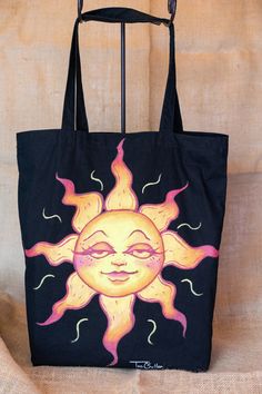 a black bag with an image of the sun painted on it's front and sides