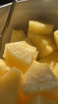 sliced up pineapples in a bowl with a spoon