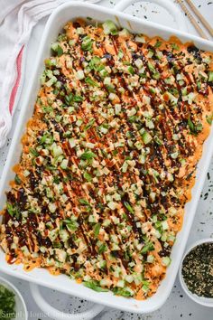 a casserole dish with carrots, celery and other toppings