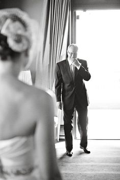 a man in a suit standing next to a woman