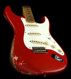 an old red and white electric guitar