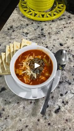 a bowl of soup and crackers on a table