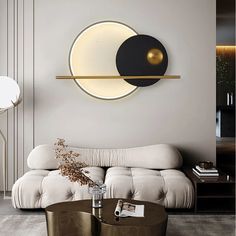 a living room with a couch, coffee table and round mirror on the wall above it