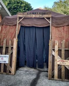 two wooden doors are open in front of a tent