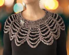 a close up of a woman wearing a black top with crochet on it