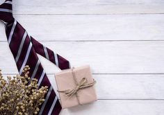 a gift wrapped in brown paper and tied with twine on top of a white wooden table