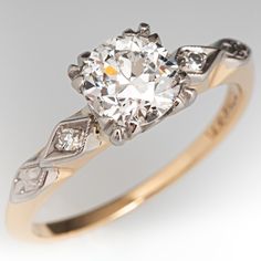 an antique diamond engagement ring in yellow gold and white gold with two diamonds on the band