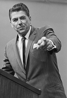 a black and white photo of a man giving a speech