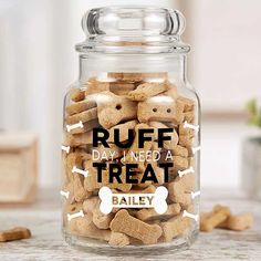 a glass jar filled with dog treats on top of a table