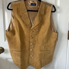 Cool, Western Like Paul Fredrick Light Tan (Gold Undertone) Leather Vest. Looks Great Over A Dress Shirt Features An Adjustable Back Buckle-Strap, And Two Front Pockets. Outer Front Material Is A 100% Supple Leather, Liner And Back Are 55% Polyester And 45% Nylon. Uncovered Two Buttons To Show In Pictures, Three Are Still Covered. Size:M Approximate Measurements Laying Flat: Pit To Pit: 20.5” Length: 23.5” Shoulder: 15” Bottom Width: 19.5” New With Tags. Never Worn. There Are A Few Minor Creases Tan Western Vest, Gold Vest Suits, Gold Leather Vest, Vintage Western Leather Vest, Western Business Casual, Tuxedo Colors, Tan Vest, Double Breasted Vest, Sweater Vest Mens