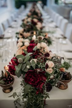 a long table is set with flowers and candles