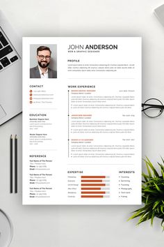 a professional resume template with an orange accent on the front and back cover, sitting on top of a desk next to a laptop