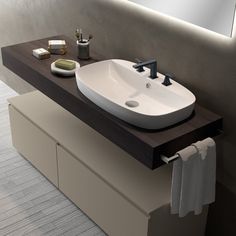 a bathroom sink sitting on top of a wooden counter