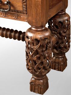 an ornate carved wooden table with drawers