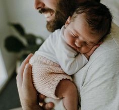 a man holding a baby in his arms