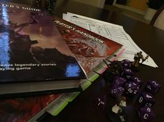 a table topped with books and dices on top of it