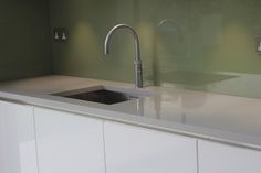 a kitchen counter with a sink and faucet in front of the counter top