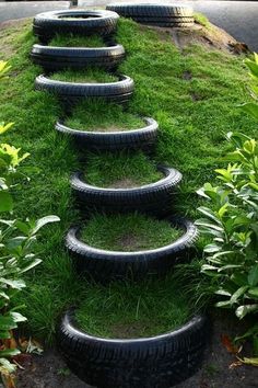 several tires are stacked on top of each other in the grass