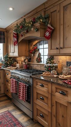 a kitchen decorated for christmas with stockings on the stove and garland hanging from the oven