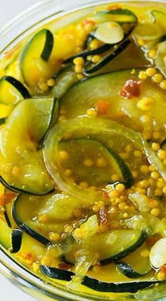 a glass bowl filled with vegetables and sauce