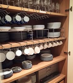 the shelves are filled with dishes and plates