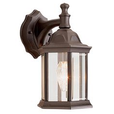 an outdoor wall light with a clear glass shade on the top and bottom half of it