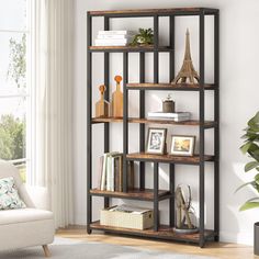 a living room with a white chair and book shelf