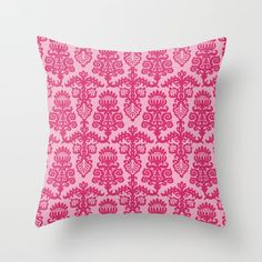 a pink pillow with an ornate design on it