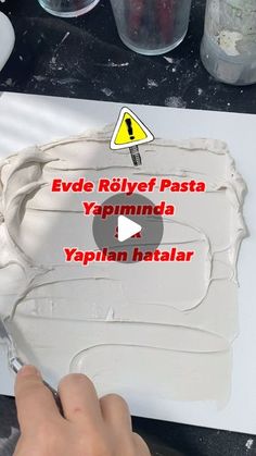 a person is making something out of clay and white paper with the words evde rhyfef pasta yapminda, yappian hatalar