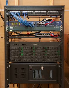 several servers stacked on top of each other in a room with wires and cables attached to them