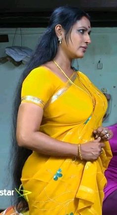 a woman in yellow sari with long hair