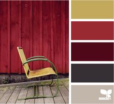 a chair sitting on top of a wooden floor in front of a red barn wall