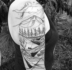 a woman with a mountain and trees tattoo on her arm, in black and white