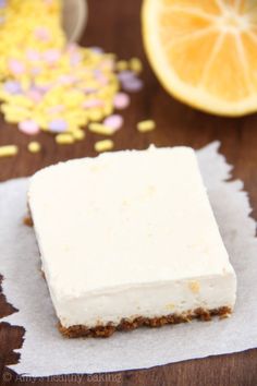 a piece of cake sitting on top of a napkin next to a slice of lemon