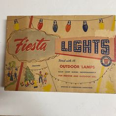 an old advertisement for fiesta lights hangs on the wall in front of a white wall