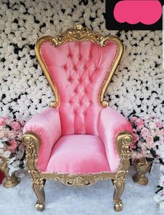 a pink chair sitting in front of a wall