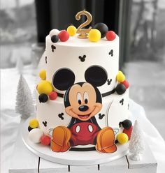 a mickey mouse birthday cake on a table