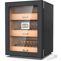 a display case with chocolates in it and an alarm clock on the front side